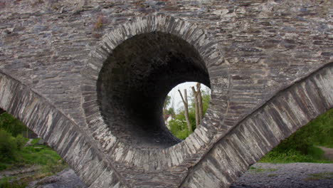shot of the man made stone holes in the cenarth bridge at cenarth falls on the river teifi
