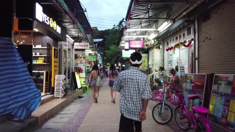 the streets of phi-phi island in evening. walking around the island. shopping street and tattoo salons