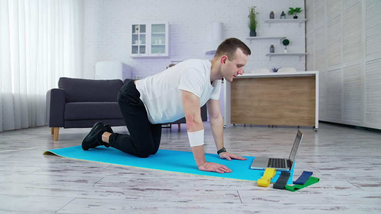 Quarantine time training indoor. Active lifestyle male doing exercises in home.