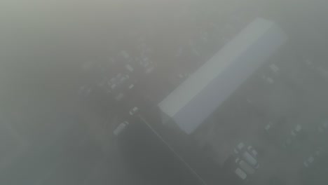 a foggy cityscape in the early morning with limited visibility, aerial view