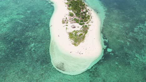 Aerial-pullback-reveals-white-sandy-beach-bungalows-of-canimeran-island-balabac