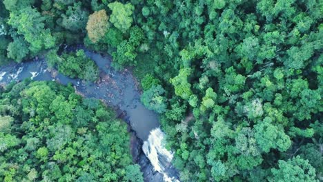 Descending-stunning-rotating-aerial-shot-of-river-and-waterfall-in-Brazilian-forest