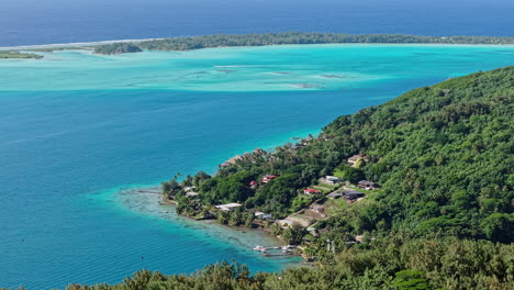 bora bora island lagoon, french polynesia. aerial view of green main island, coastline and motu islets, drone shot