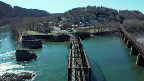 harpers ferry west virginia usa, aerial dolly along train tracks to historic downtown overlooking the river