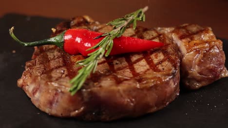 grilled rib eye steak with rosemary and chili peppers