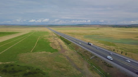 drone shot of a motorway surrounded by agriculture fields