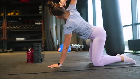 woman performing back and core exercises in a gym