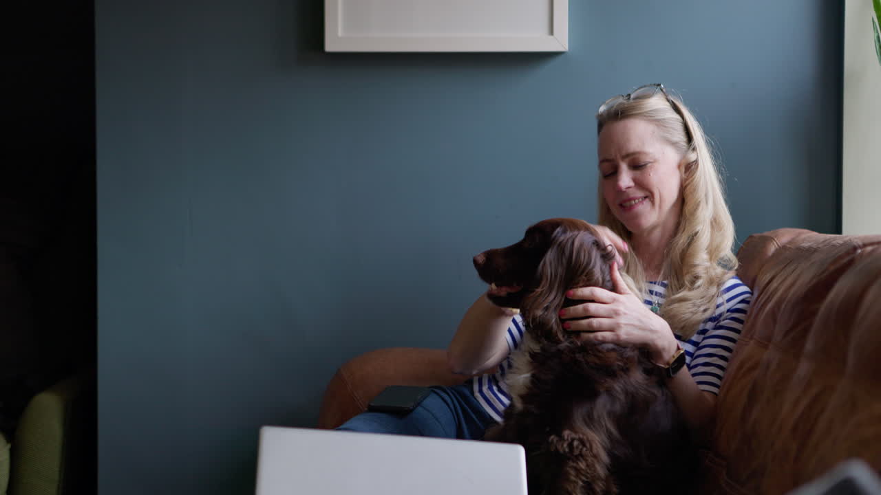 A woman relaxing on a couch using her smartphone