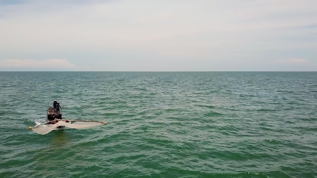 Two people fishing in the ocean in Vietnam