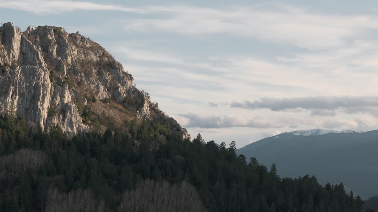 Drone captures rocky mountains with towering peaks and rugged cliffs