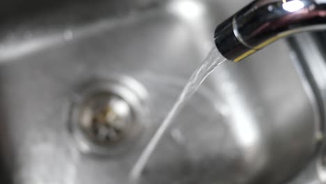 water pouring from a faucet tap slow motion