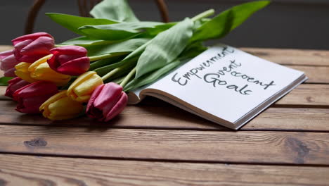 motivational message with flowers on wooden table
