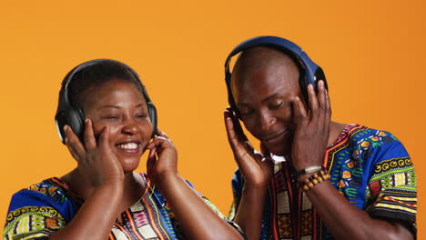 african american partners dancing on headset music in studio