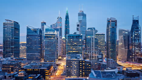 cityscape at dusk with modern skyscrapers and lit buildings