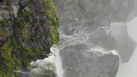 the wind disrupts the flow of the waterfall