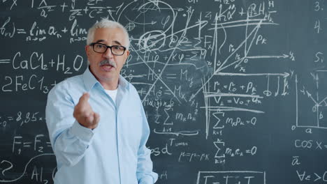 teacher explaining math formulas on a chalkboard