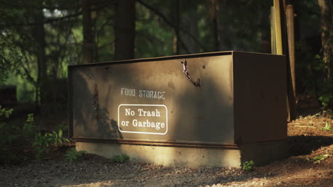 an animal proof food storage safe at a campsite in glacier national park