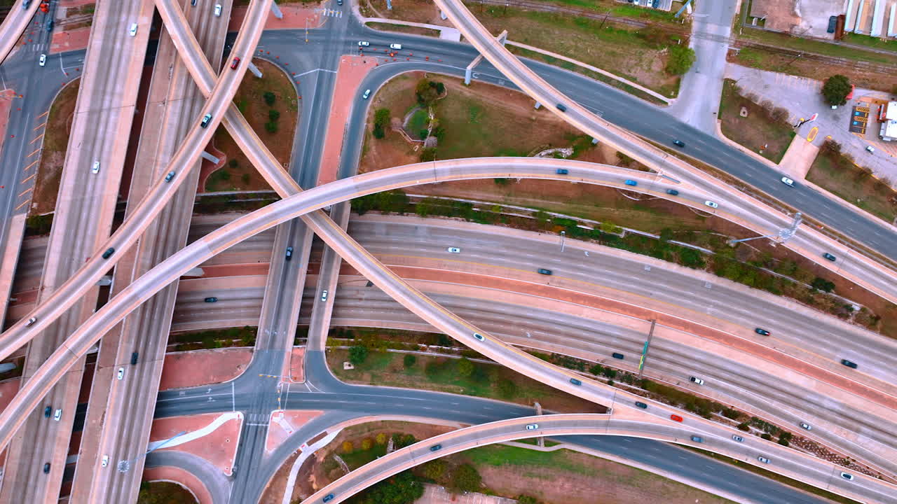 Hectic traffic on the highways and trestles to the diverse sides of the metropolis. Complicated system of roads in the modern city. Top view