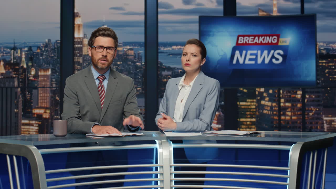 Anchors talking breaking news evening television studio closeup. Hosts speaking
