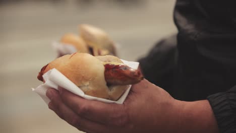 close-up of a bratwurst with ketchup in bread from a grillwalker hot dog stand in alexanderplatz, berlin