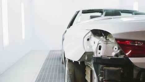 destroyed car standing in a township workshop being prepared to be repaired