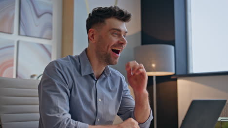 happy businessman winning achievement in office closeup. excited winner reacting
