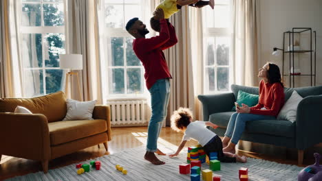 a family playing together in a bright living room