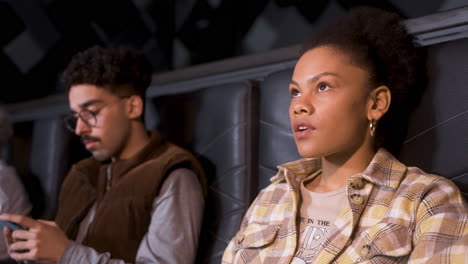 side view of an african american couple sitting in a vip cinema