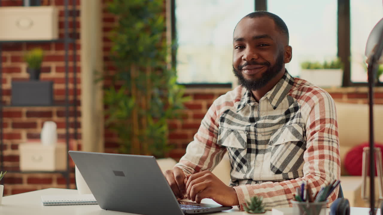 Office employee sitting at desk and using laptop