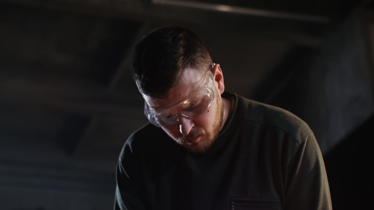 Focused Metalworker in Workshop