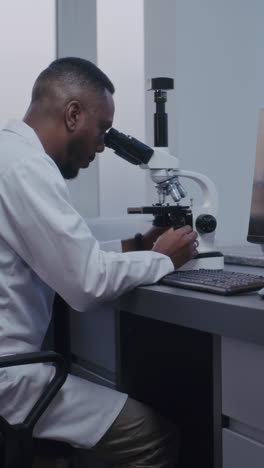 scientist using a microscope in a laboratory