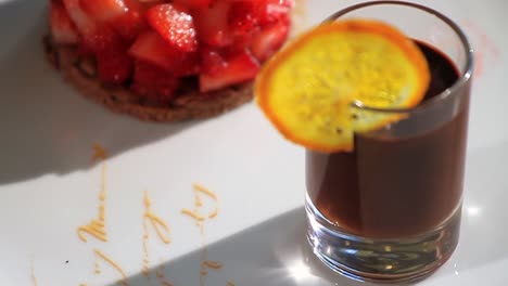 chocolate dessert with berries and orange slice