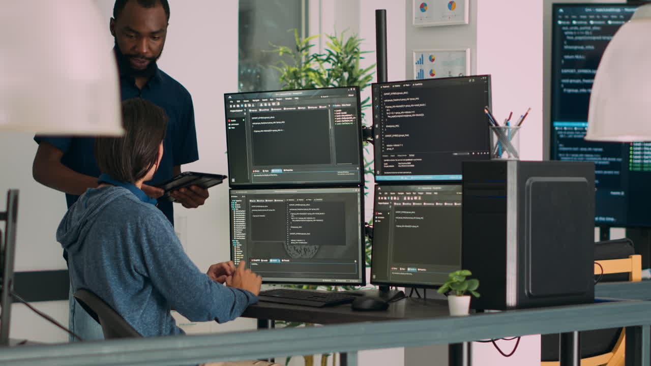 Diverse programmers collaborating on coding project compiling algorithm