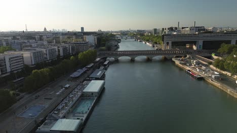 pont de bercy bridge with josephine baker pool in foreground and ministry of economics and finance new palace on the other bank, paris in france