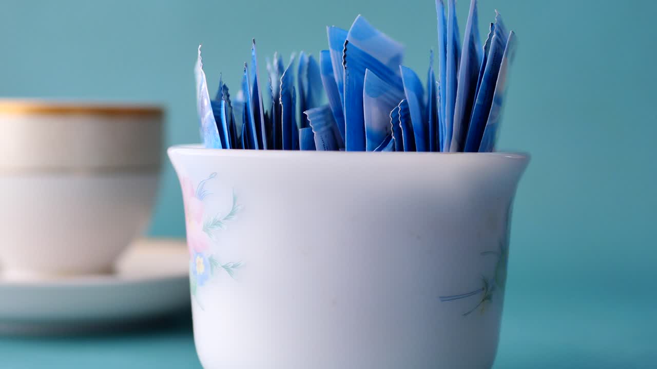 paquetes de azúcar en un recipiente decorativo