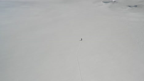 4k drone footage of backcountry skiers ascending glacier