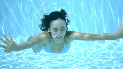 happy young woman smiling underwater