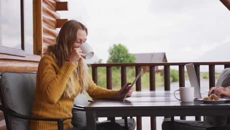 caucasian couple spending time at home together, sitting outside the cabin