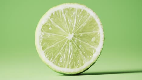 video of sliced lime with copy space over green background