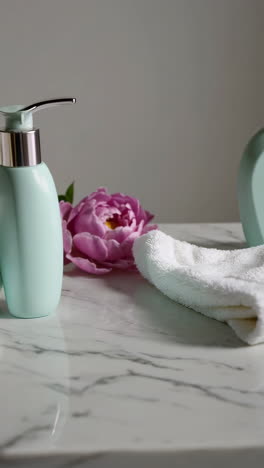 mint green soap dispenser and white towel set