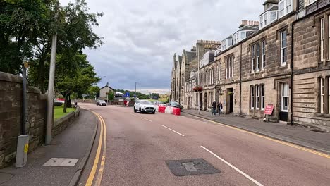 cars and pedestrians on a scottish street