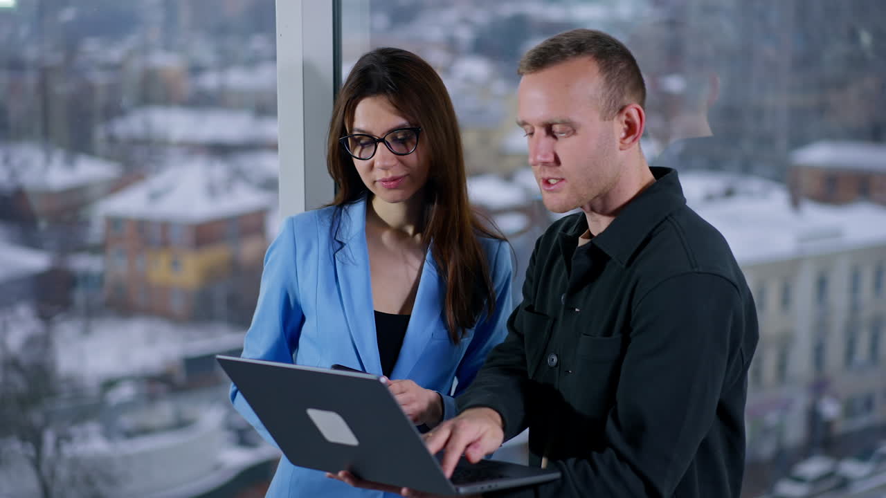 Business Colleagues Discussing Project at Office Window
