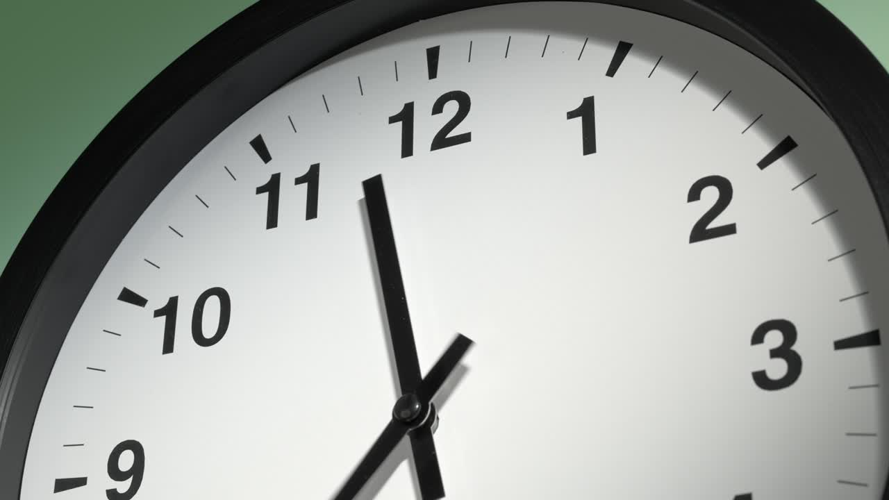 Clock Face on Light Green Wall in Time Lapse