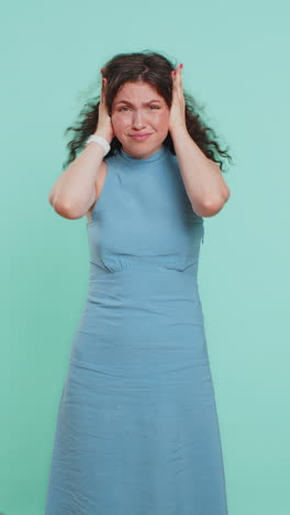 annoyed irritated young woman covering ears gesturing no avoiding advice ignoring noise loud voices