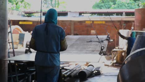 worker operating a crave in metal industry