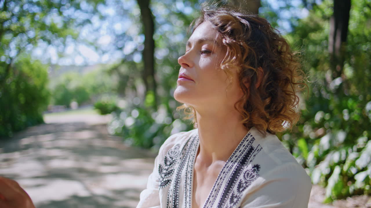 Closeup mother touching daughter sunshine park resting together. Mom squatting