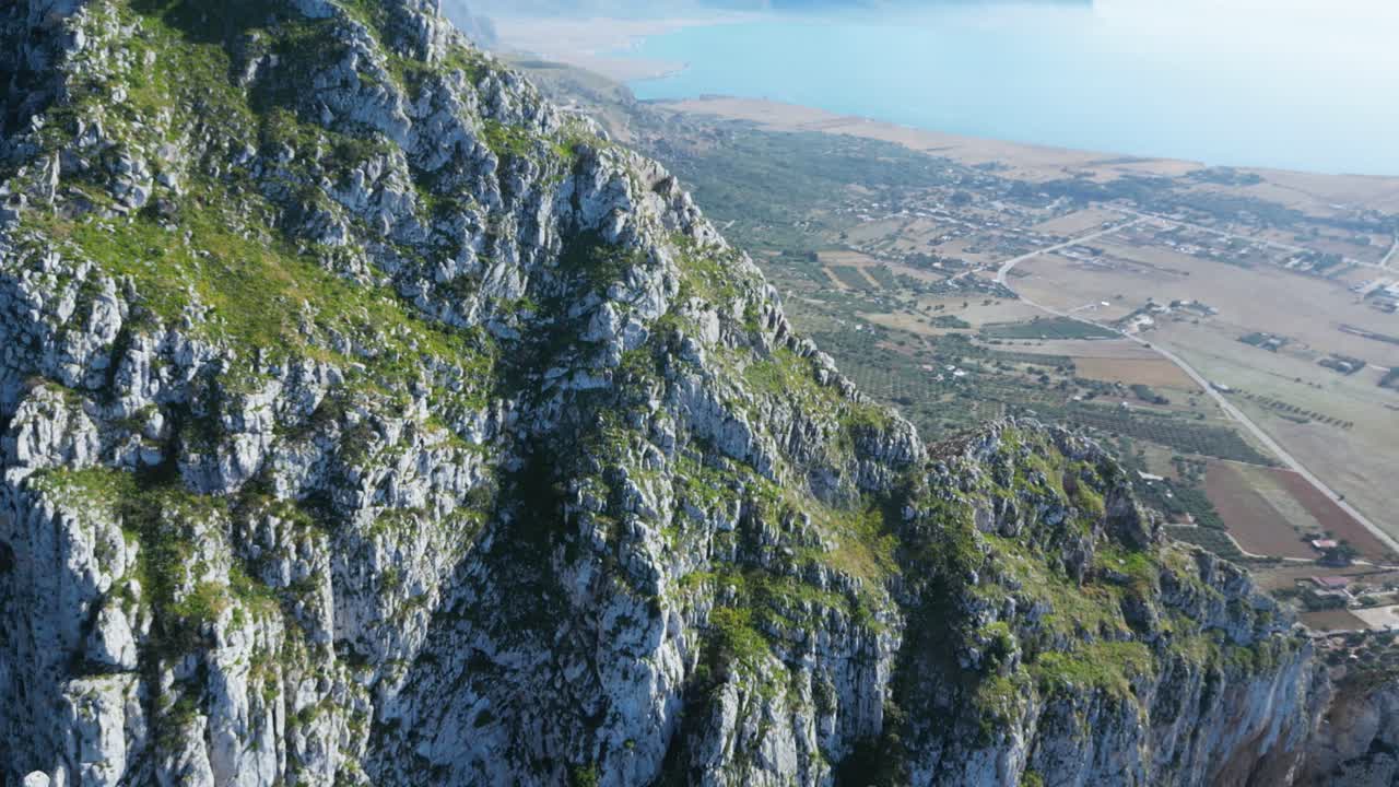 Aerial drone footage of Monte Monaco, San Vito Lo Capo, Sicily: 360° panoramic view of sea and mountains under golden Mediterranean light. Perfect for travel, nature, and adventure projects