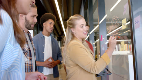 happy diverse creative colleagues brainstorming making notes on glass wall, slow motion