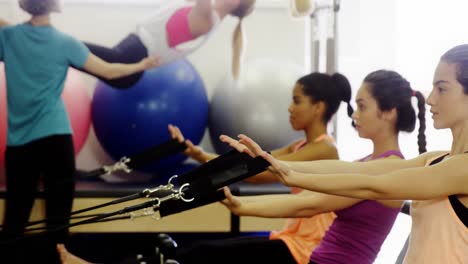 Beautiful-women-exercising-in-fitness-studio