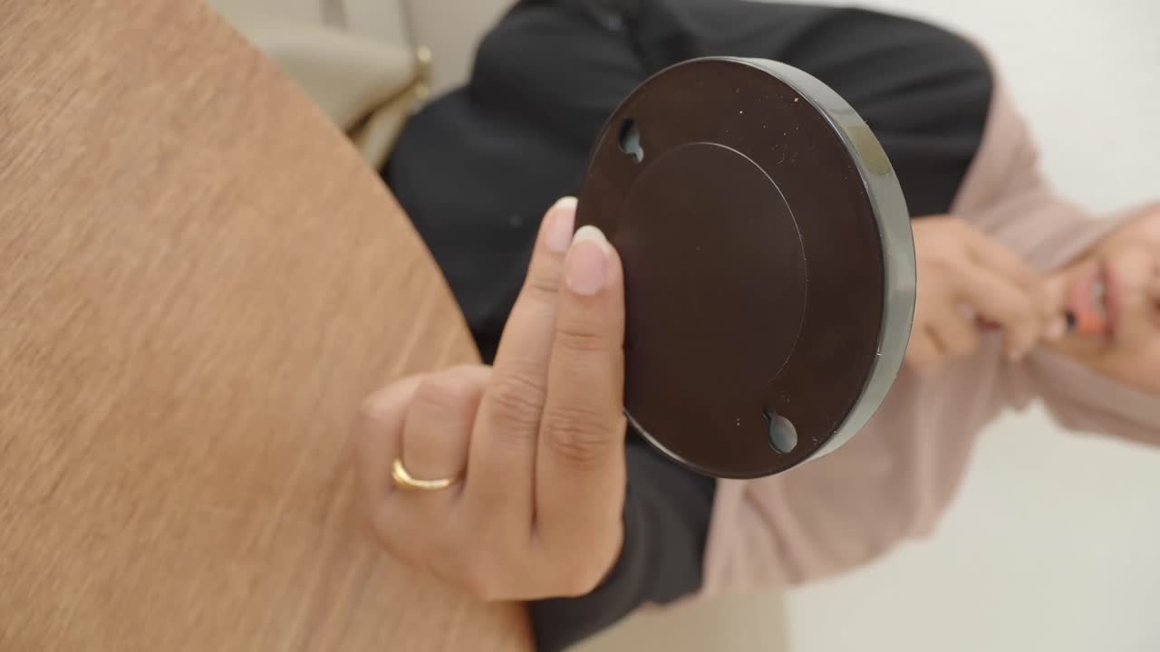 Woman in hijab holding a brown object